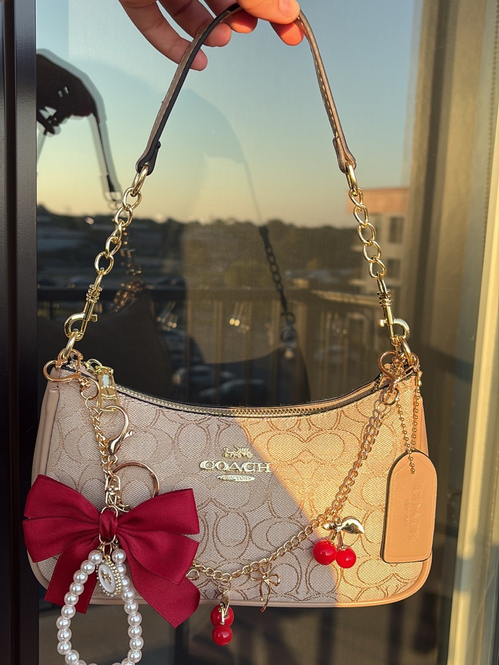 Coach Beige Signature Canvas Shoulder Bag with Red Charm